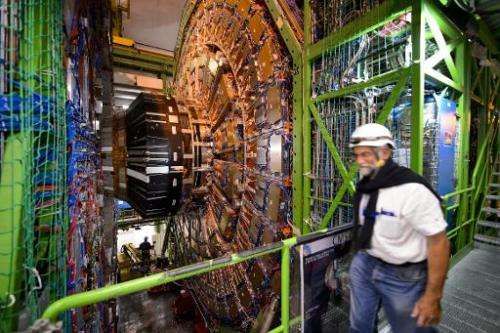 A worker walks past the Compact Muon Solenoid, a general-purpose detector at the European Organisation for Nuclear Research (CER