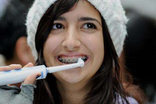 A young woman takes part in a teeth brushing promotion in Sydney on August 3, 2009