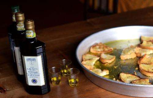 Bottles of olive oil and toasted bread with olive oil at the Buonamici Farm in Fiesole, Tuscany, on December 2, 2014