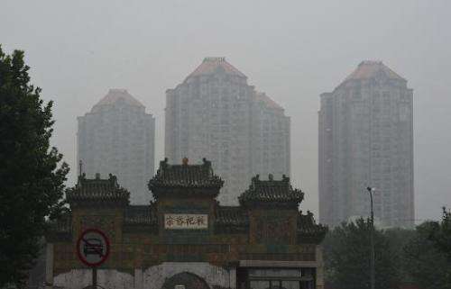 Buildings can be seen through polluted skies in Beijing, July 3, 2014 2014