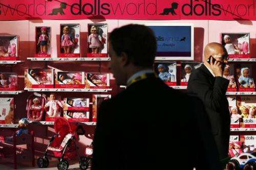 Businessmen look at the Doll World stand during the annual Toy Fair at the Olympia exhibition centre in London, on January 21, 2
