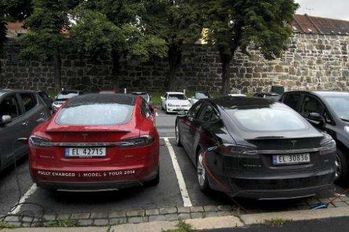 Cars are seen charging in free parking spaces for electric cars in central Oslo on August 19, 2014