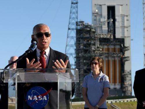 Charles F. Bolden, Jr., NASA Adminstrator, speaks to the media near the United Launch Alliance Delta 4 rocket, carrying NASA's f
