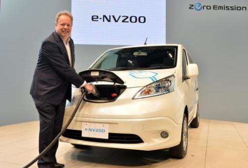 Chief planning officer for Japan's auto giant Nissan, Andy Palmer, poses with the company's new commercial electric vehicle &quo