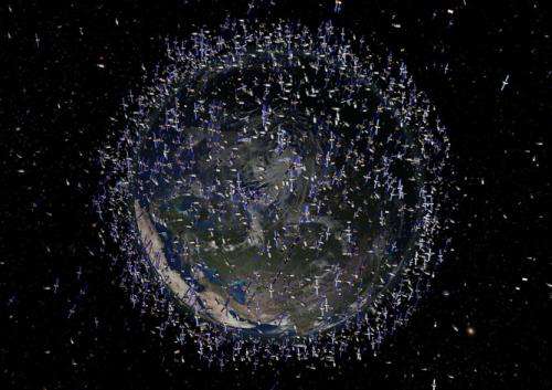 Cleaning up space debris with sailing satellites