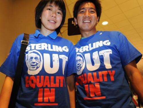 Clippers fans Kitty Siu (L) and Alvy Chen wear tee shirts calling for Donald Sterling to sell the Los Angeles Clippers on April 