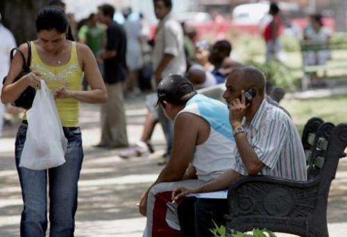 Cubans use their cell phones in Havana on May 8, 2008