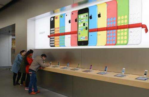 Customers looking at iPhones in an Apple store in Shanghai, on January 14, 2014