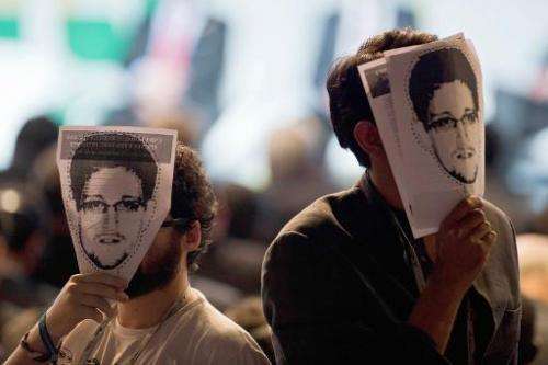 Demonstrators hold portraits of Edward Snowden at a protest during the opening ceremony of the &quot;NETmundial  Global Multist