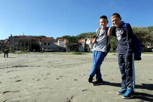 Dominik Malovic (L) and Ivan Macic (R) posing on beach near their school on the small remote island of Susak in Croatia's northe