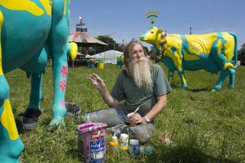 EE's Wi-Fi cows receive finishing touches from onsite artist Hank Kruger at Glastonbury