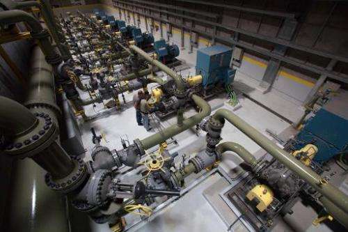 Emplyees work in the pump room at the Gorona power station on El Hierro island on March 28, 2014