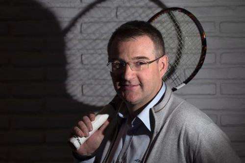 Eric Babolat, the CEO of a company specialized in tennis equipment, poses with a new 'connected' racket, in Paris, on March 13, 