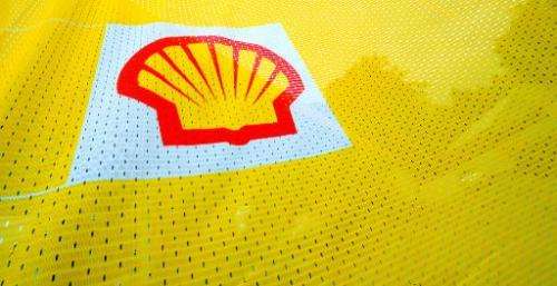 e Shell logo is seen on a flag outside a Shell petrol station in Fleet, Hampshire in southern England on July 29, 2010