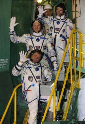 European Space Agency's German astronaut Alexander Gerst (C), Russian cosmonaut Maxim Suraev (bottom) and US NASA astronaut Greg