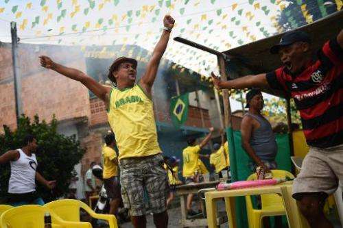 Fans of Brazil react at the end of the match in Porto Seguro on June 28, 2014