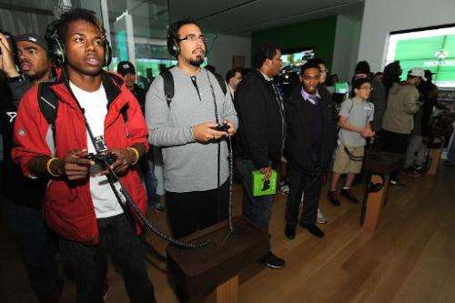 Fans play newly released Xbox One games at the Microsoft retail store at Tysons Corner Center on November 21, 2013 in McLean, Vi
