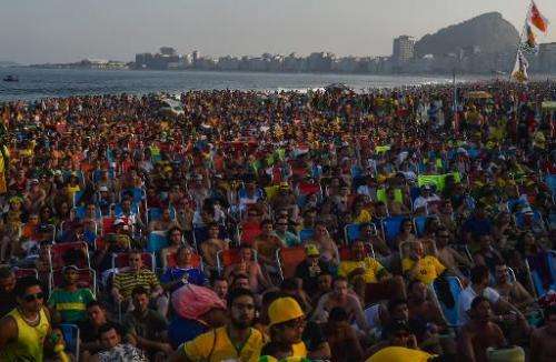 Fans watch a live broadcast of the World Cup match between Brazil and Mexico at Copacabana beach in Rio de Janeiro on June 17, 2