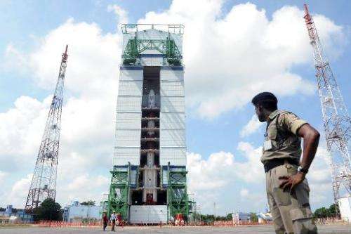 File photo taken on October 30, 2013 shows a security forces member keeping watch on the PSLV-C25 launch vehicle at the Indian S