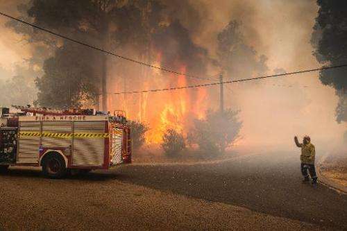 Firefighters try to contain wildfires in the Stoneville area, a suburb east of Perth in the state of Western Australia on Januar