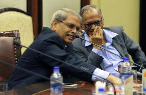 Founders of Indian IT firm, Infosys Technology N.R. Narayana Murthy (R) and Kris Gopalakrishna share a light moment at a media i