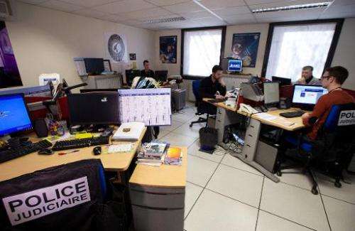 French police officers of the PHAROS internet investigation unit work in Nanterre, near Paris, on February 4, 2014. PHAROS is pa