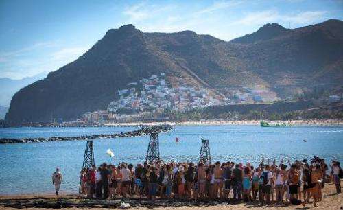 Greenpeace volunteers gather on Playa de Las Teresitas during a protest of Spain's decision to explore plans for oil and gas off