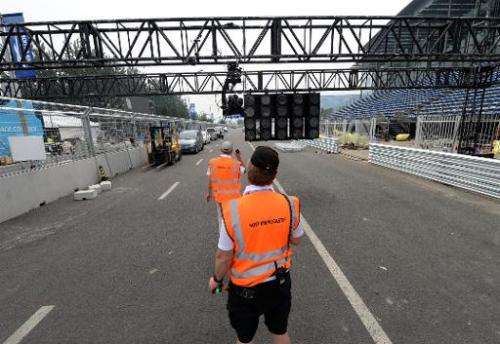 Host broadcasters set up their cameras along the race track for the Formula E debut in Beijing on September 11, 2014