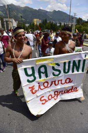 Huaorani natives and Yasunidos ecologist group activists march in Quito on April 12, 2014 towards the National Electoral Council