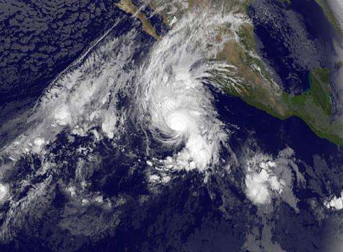 Hurricane Vance dwarfs developing low pressure area