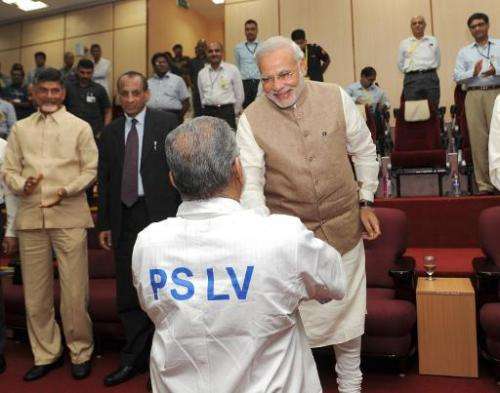 In a photo released by the Press Information Bureau (PIB) on June 30, 2014, Indian Prime Minister Narendra Modi (R) congratulate