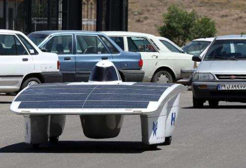 Iranian students from the Qazvin Azad Islamic University test drives the solar-powered Havin-2 vehicle in Qazvin on June 2, 2014