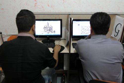 Iranians use computers at a cybercafe in central Tehran. Authorities are developing a system to identify any Internet user in th