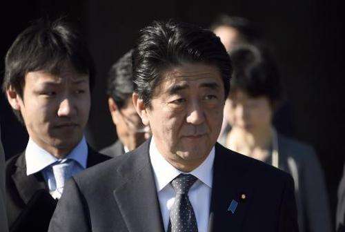 Japanese Prime Minister Shinzo Abe leaves is welcomed at the Invalides in Paris on May 5, 2014