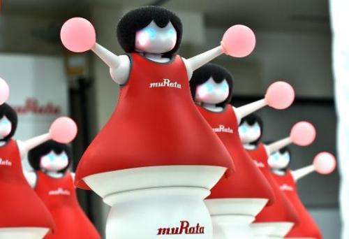 Japan's Murata Manufacturing unveils 10 small cheerleading robots, in Tokyo on September 25, 2014