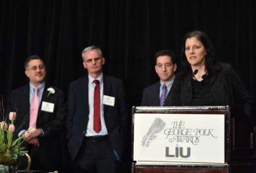 Laura Poitras (R) and Glenn Greenwald (2nd R) with The Guardian's Ewen MacAskill (2nd L) and Barton Gellman (L) of The Washingto