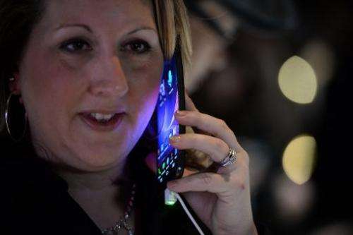 LG representative Amy Sanchez holds LG's new G Flex curved screen smartphone during the LG press conference at the Mandalay Bay 