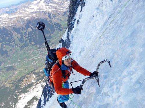 Mountaineer Daniel Arnold climbs the Eiger's north face with a custom-made camera mounted on his backpack, in Switzerland, on Ap