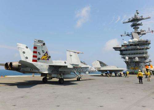 Navy tests drone landings on aircraft carrier along with manned plane