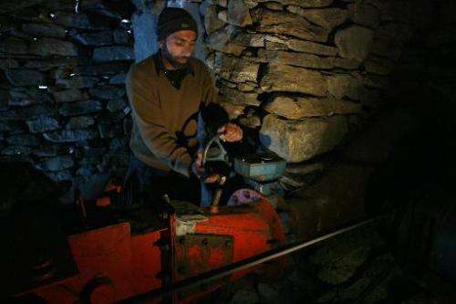 Pakistani Kashmiri technician Rahimullah operates a turbine at a small-scale hydro project in the mountainous Neelum Valley in P