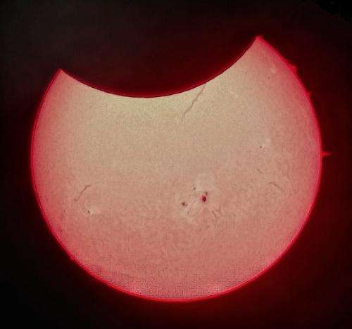Partial solar eclipse shows off massive sunspot