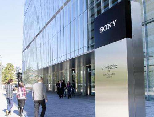 Pedestrians pass before the headquarters of Japanese electronics giant Sony in Tokyo on January 13, 2009