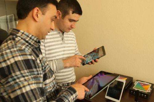 People check out Armenia's first tablet computers, ArmTabs, designed by the joint Armenian-US company Minno, in Yerevan, on Marc