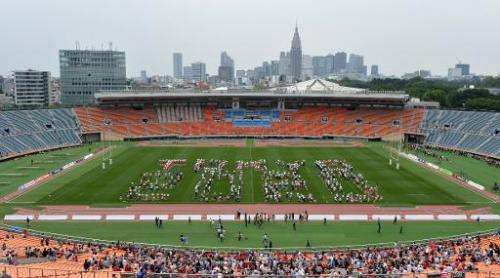 People gather on the field of the National Stadium in Tokyo on May 25, 2014 to spell out &quot;Tokyo 2020&quot;