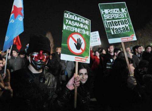 People shout slogans as they hold placards that read &quot;stop censorship&quot; during a rally against a bill that allow Turkey