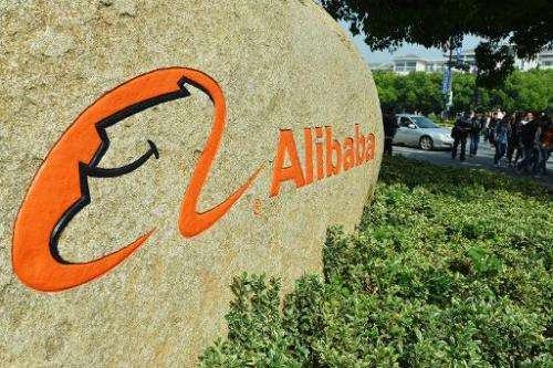 People walk past the entrance of the Alibaba headquarters in Hangzhou, east China's Zhejiang province on May 7, 2014