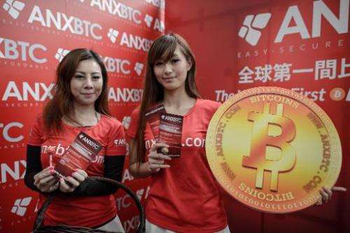 Promotion girls pose during the opening ceremony of the city's first bitcoin retail shop in Hong Kong on February 28, 2014