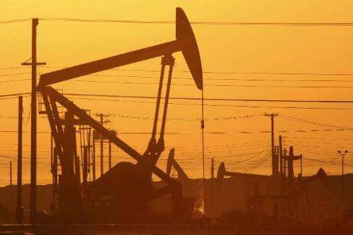 Pump jacks are seen at dawn in an oil field on March 24, 2014 near Lost Hills, California