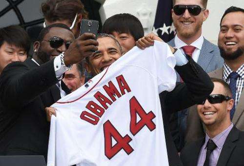 Red Sox Designated Hitter David Ortiz (L) takes a &quot;selfie&quot; with US President Barack Obama during a ceremony on the Sou