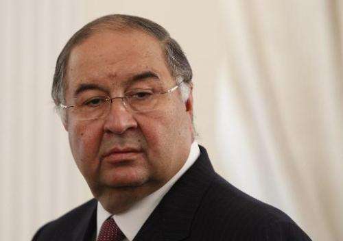 Russian businessman Alisher Usmanov attends a meeting outside of Moscow on September 12, 2013